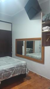 a bedroom with a mirror and a bed in it at HotelesR20 in Lima