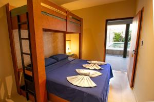a bedroom with a bunk bed with two pillows on it at Casa Ananda Hotel Boutique in Canoa Quebrada +47 photos