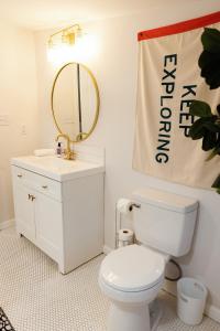 a bathroom with a toilet and a sink and a mirror at Seabiscuit Loft - Studio in Downtown Lexington in Lexington +8 photos