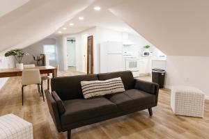 a living room with a couch and a table at Seabiscuit Loft - Studio in Downtown Lexington in Lexington
