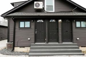 a black house with black doors and stairs at Seabiscuit Loft - Studio in Downtown Lexington in Lexington