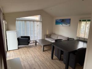 a living room with a table and a couch at First houses 82 in Rijen