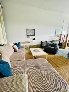 a living room with two couches and a table at Oceans3 - Spectacular View 'N' Jetty Access in Ocean Shores