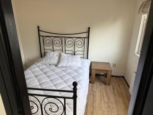 a bedroom with a black and white bed and a table at First houses 82 in Rijen