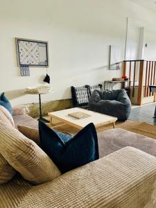 a living room with couches and a table at Oceans3 - Spectacular View 'N' Jetty Access in Ocean Shores