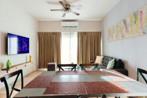 a living room with a table and chairs and a couch at Costa Apartments in La Paz