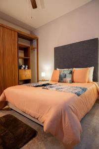 a bedroom with a large bed with orange pillows at Costa Apartments in La Paz +119 photos