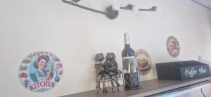 a shelf with a bottle of wine and a box at Le cabanon du plaisir in Montpellier +8 photos