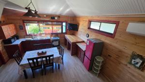 an aerial view of a kitchen and dining room in a tiny house at Cabañas y hostal Aurora in Castro