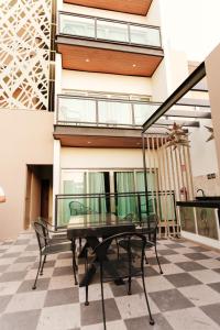 a glass table and chairs on a checkered floor at Costa Apartments in La Paz