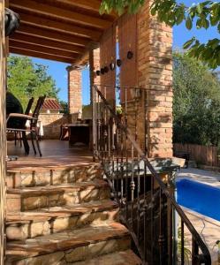 a wooden staircase leading to a house with a swimming pool at Villa Doba - Visnjan in Višnjan