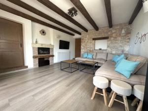 a living room with a couch and a stone wall at Villa Doba - Visnjan in Višnjan