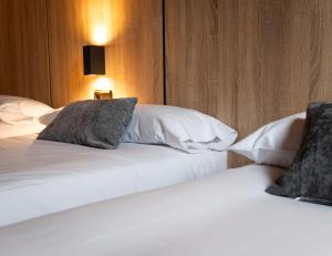 two beds sitting next to each other in a hotel room at Hotel Nau Iori in Vielha