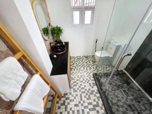 a bathroom with a shower and a sink and a toilet at Evolve SAYA in Talawatugoda +8 photos