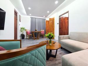 a living room with a couch and a table at Evolve SAYA in Talawatugoda