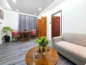 a living room with a couch and a table at Evolve SAYA in Talawatugoda