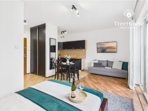 a living room with a couch and a table at Apartament Pasaż 3 in Giżycko