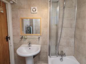 a bathroom with a sink and a shower at Corner Cottage in Seahouses +29 photos