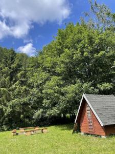 a small house in a field with trees at Chalupa U Revíru in Chvalčov