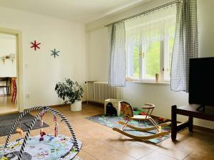 a living room with two chairs and a table at Chalupa U Revíru in Chvalčov