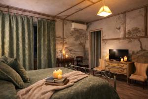 a bedroom with a bed with candles on it at VesConte Residenza D'epoca dal 1533 in Bolsena