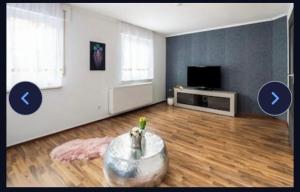 an empty living room with a table and a tv at Haus Schwarzwald Marie in Mahlberg