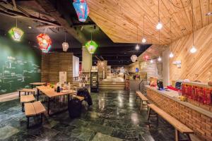 a restaurant with wooden walls and tables and benches at MEANDER Taipei in Taipei