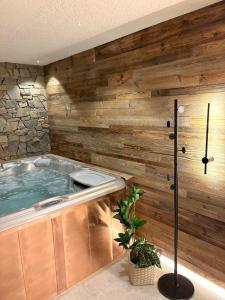 a jacuzzi tub in a room with wooden walls at Apartamenty 1006mnpm JACUZZI w cenie in Bustryk +41 photos