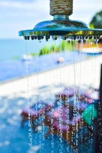 a close up of a fountain with water dripping from it at Sea Garden Resort Haad Chao Phao in Haad Chao Phao