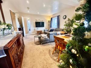 a living room with a christmas tree and a couch at Kearton Guest House in Thwaite