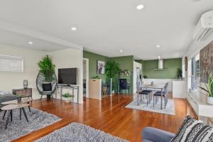 a living room with a couch and a table at Bliss on Third in Whangarei