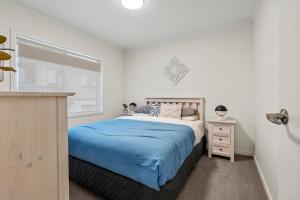 a bedroom with a large bed and a window at Bliss on Third in Whangarei