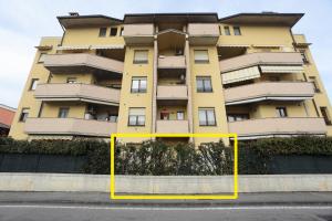 a yellow apartment building with a yellow box in front of it at Armanni's House in Orio al Serio