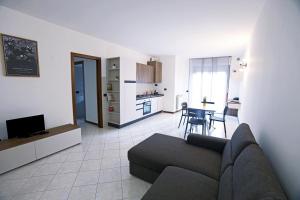 a living room with a couch and a dining room at Armanni's House in Orio al Serio