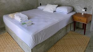 a large bed with white sheets and towels on it at Soiree in Zipolite +55 photos