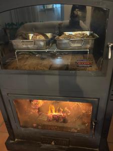 two ovens with food cooking inside of it at La Casa Grande in Benaocaz