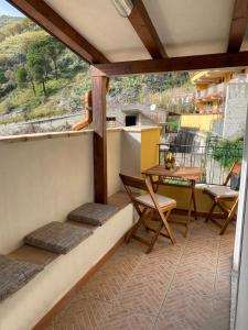 a balcony with a table and chairs and a view at Casa zia Vincenzina in Casalvecchio Siculo +46 photos