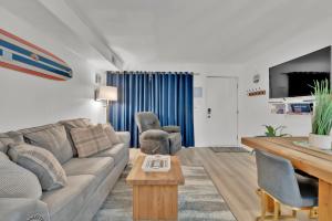 a living room with a couch and a table at Fenwick Woods OC in Ocean City