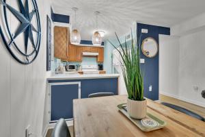 a kitchen with a wooden table with a plant on it at Fenwick Woods OC in Ocean City