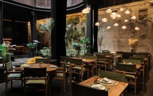 a dining room with wooden tables and chairs at Volga, Member of Preferred Hotels & Resorts in Mexico City +30 photos