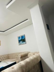 a living room with a couch in a white room at Kigali Clever Homes Villa in Kigali