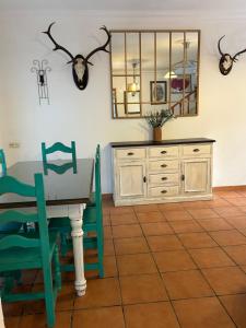a dining room with a table and chairs and a mirror at La Casa Grande in Benaocaz