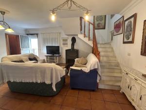 a room with two beds and a staircase at La Casa Grande in Benaocaz