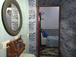 a bathroom with a mirror and a sink at Dar Enouiina in Fez