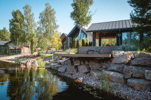 a house with a pond in front of it at Sherlock Home in Czarnówiec