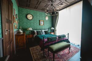 a bedroom with a bed and a clock on the wall at Sherlock Home in Czarnówiec +34 photos