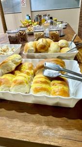 a table with two trays of breads on it at Palladium Hotel in Rio Piracicaba