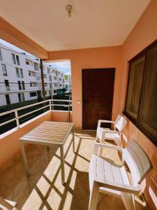 a balcony with a table and two chairs on it at Tropical Breeze Holidays in Santa Maria