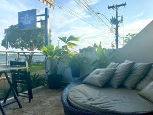 a couch sitting on top of a patio with a table at Hotel Xingu in Altamira