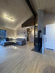 a living room with a couch and a fireplace at FjordCabin Preikestolen in Strand